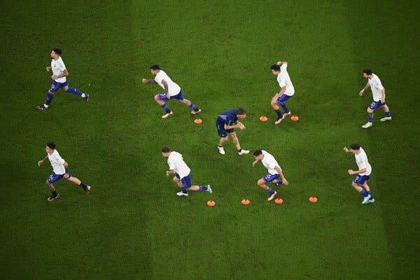 Players from Argentina run through orange lanes on the field.